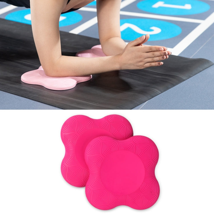 Pair of bright pink flat yoga elbow and knee pads with textured swirl grip surface