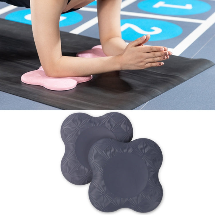 Pair of charcoal gray flat yoga elbow and knee pads with textured swirl grip surface