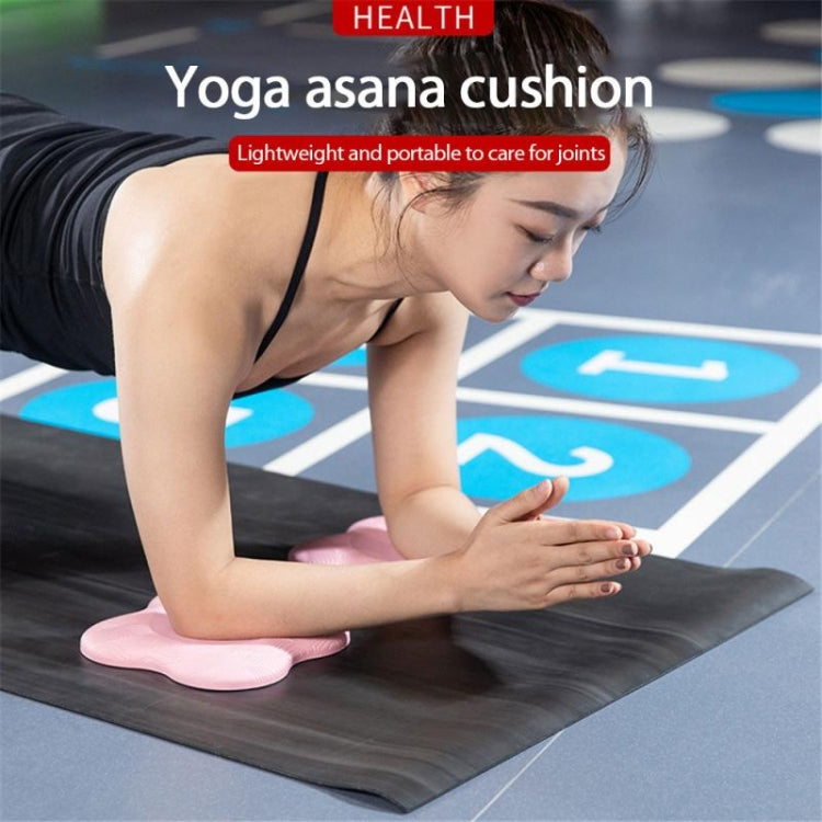 Pink flat yoga knee/elbow pad with ridged grip, under hand during exercise