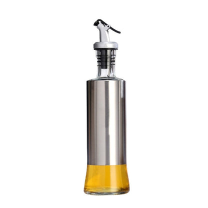 Stainless steel oil bottle with glass reservoir and pump spout, amber oil inside