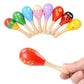 Child holding colorful sand hammer with painted head on a wooden handle