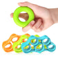 Green silicone finger grip ring in hand with blue, orange, and green grips beside it.