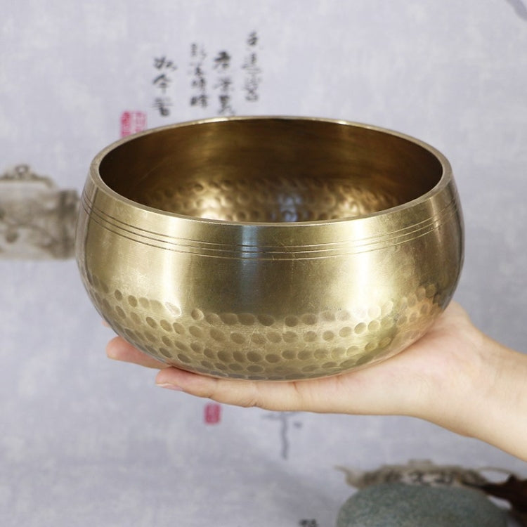 Buddha metal sound bowl held in a person’s hand