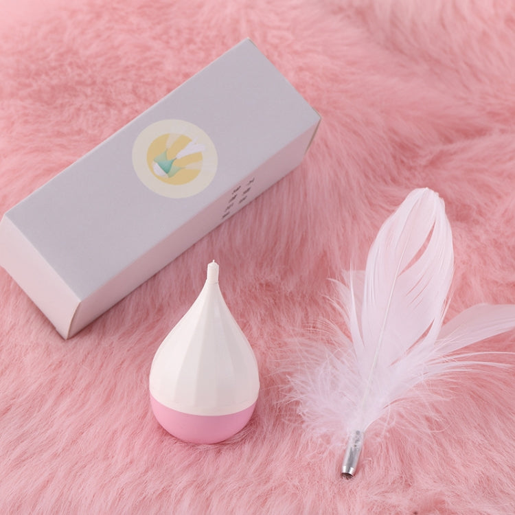 Feather tumbler cat toy with white feather topper, purple-and-pink base, in box