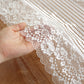 White lace table runner close-up with floral lace trim and striped vertical pattern