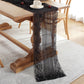 Black lace table runner with scalloped edges and vertical striped center panel