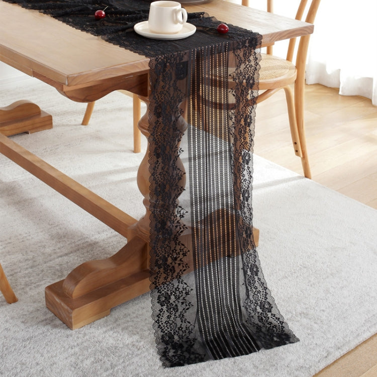 Black lace table runner with scalloped floral edges and vertical stripe pattern