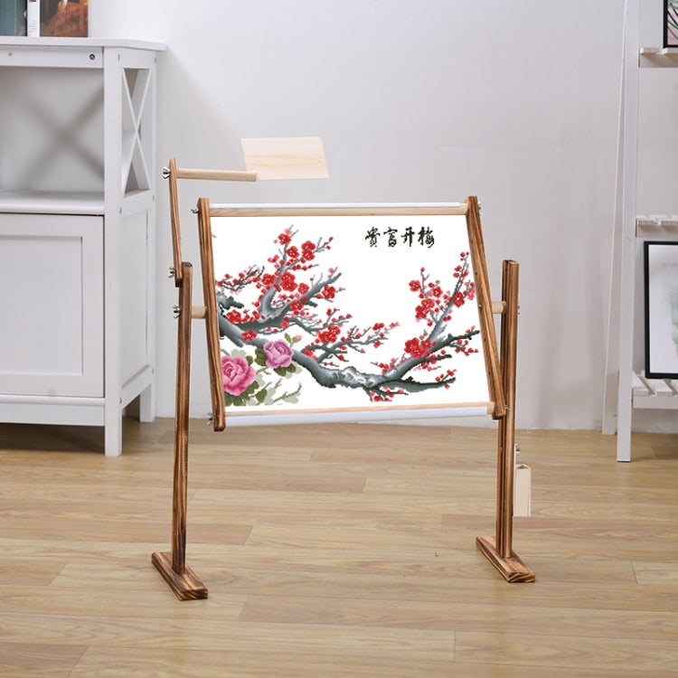 Adjustable pine cross-stitch stand holding a red and pink floral needlework panel