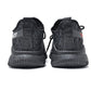 Black knit sneakers, back view with elastic collar and lace-up front
