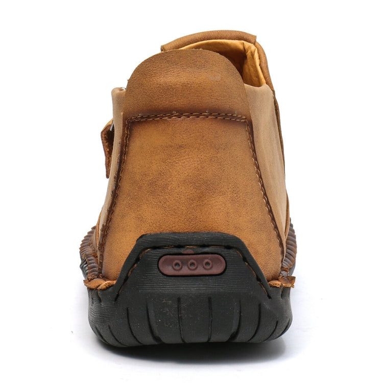 Men's tan leather ankle boots with padded collar and black rubber tread sole