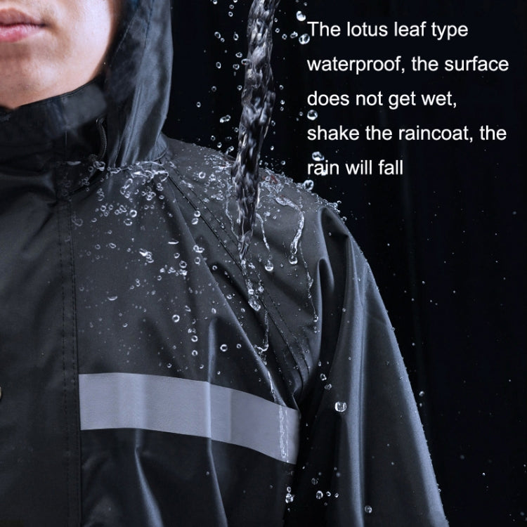 Black raincoat chest close-up with reflective band and water droplets on fabric.