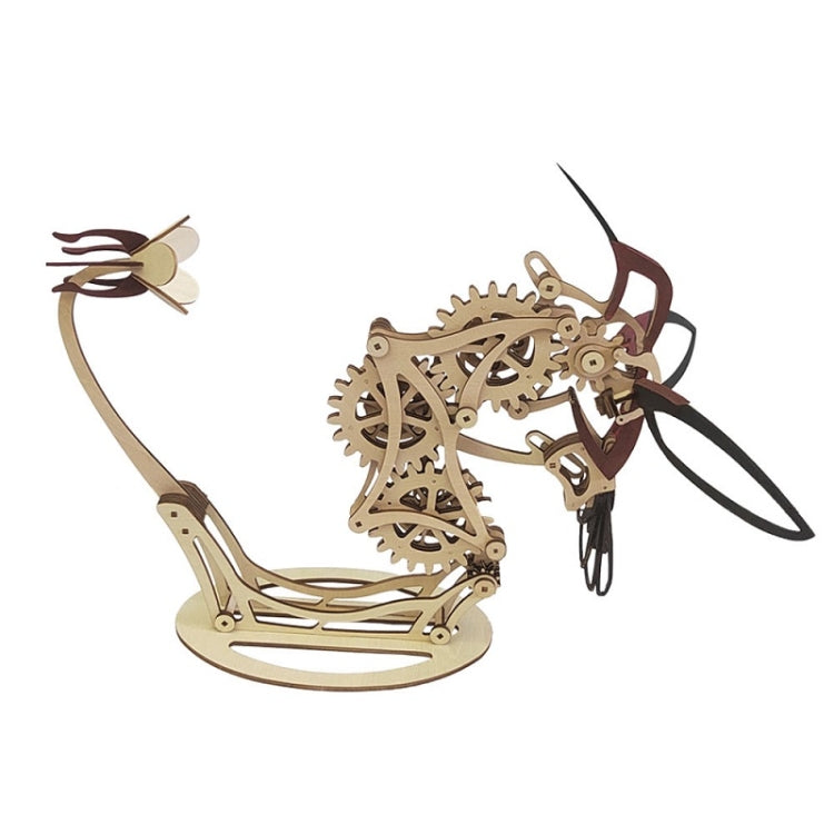 Mechanical hummingbird puzzle model, tan gears with dark legs and red wing accents