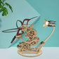 3D wooden mechanical hummingbird puzzle with black tail fins on tan base