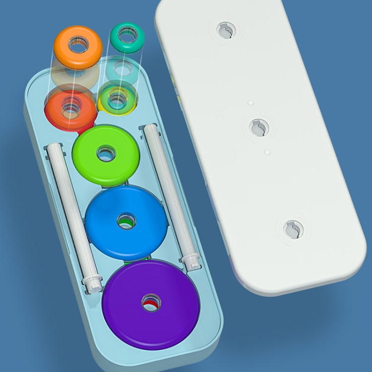 Color disc pieces and white rods for Tower of Hanoi stacking toy in a plastic tray