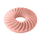 Round dog food puzzle toy in pink with ridged donut design and center hole
