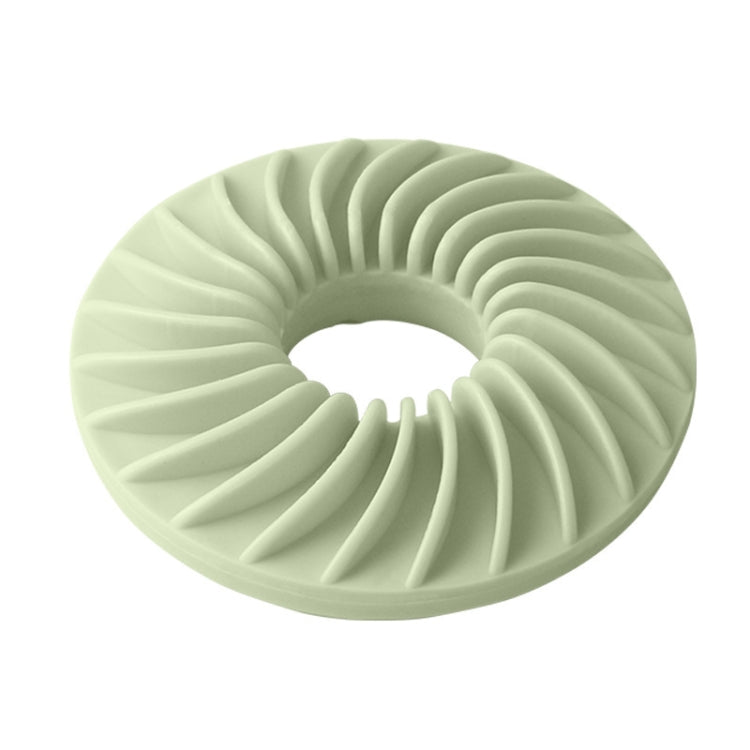 Round dog food puzzle toy in green with ridged donut design and center hole