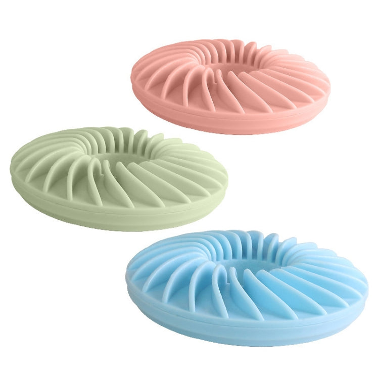 Round dog food puzzle toy set with pink, green, and blue ridged donut shapes