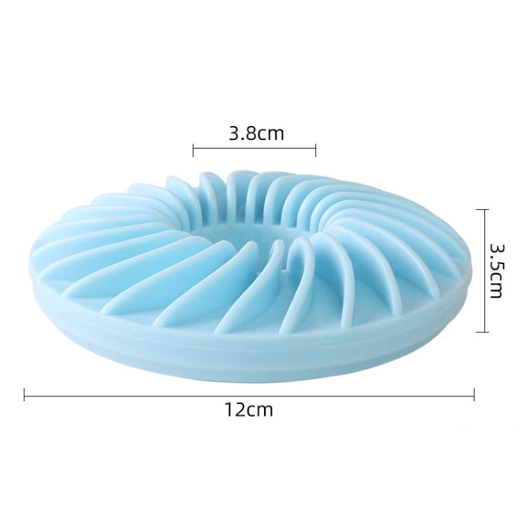 Blue round dog food puzzle toy with ridges and a center opening