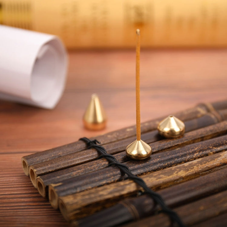 Gold incense insert plate with burning incense stick inserted through top