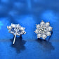 Silver flower stud earrings with round center; metal posts visible