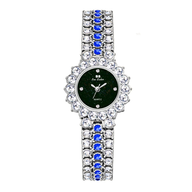 Women’s rhinestone strap watch with dark green dial and blue stone bezel on silver band