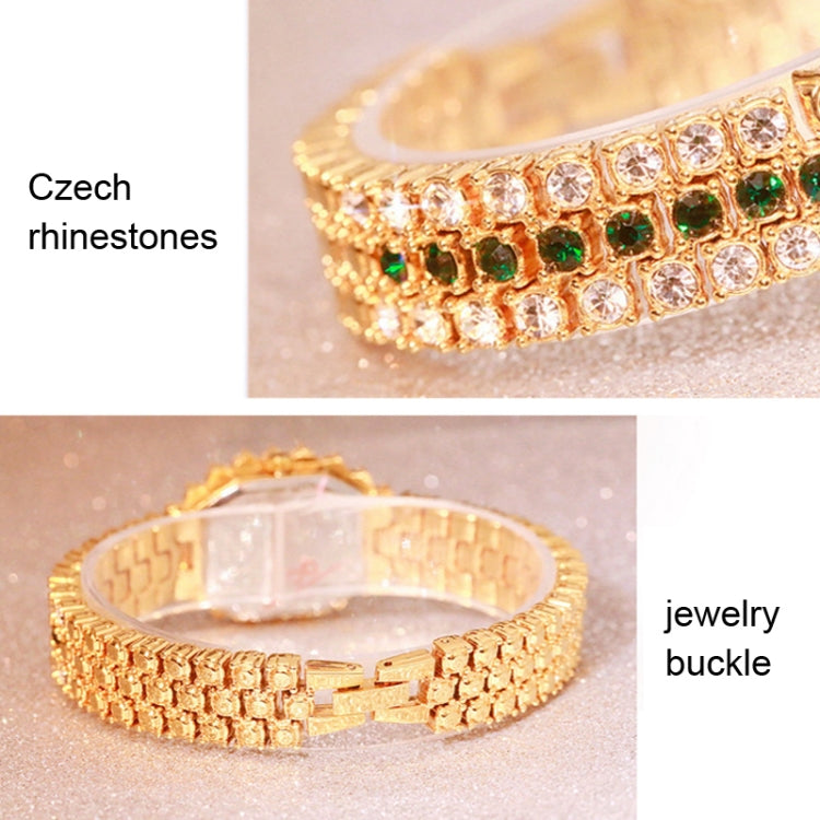 Gold-tone rhinestone watch bracelet with buckle closure and green stone detailing