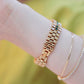 Women’s gold-tone rhinestone chain watch with green gem bracelet and clasp