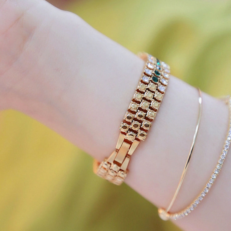 Women’s gold-tone rhinestone chain watch with green gem bracelet and clasp