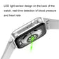 Smartwatch back with circular LED sensor and green indicator light, on white band