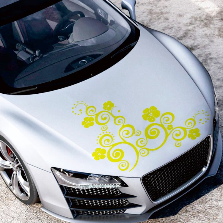 Yellow floral totem car hood sticker with curled swirls and flower shapes.