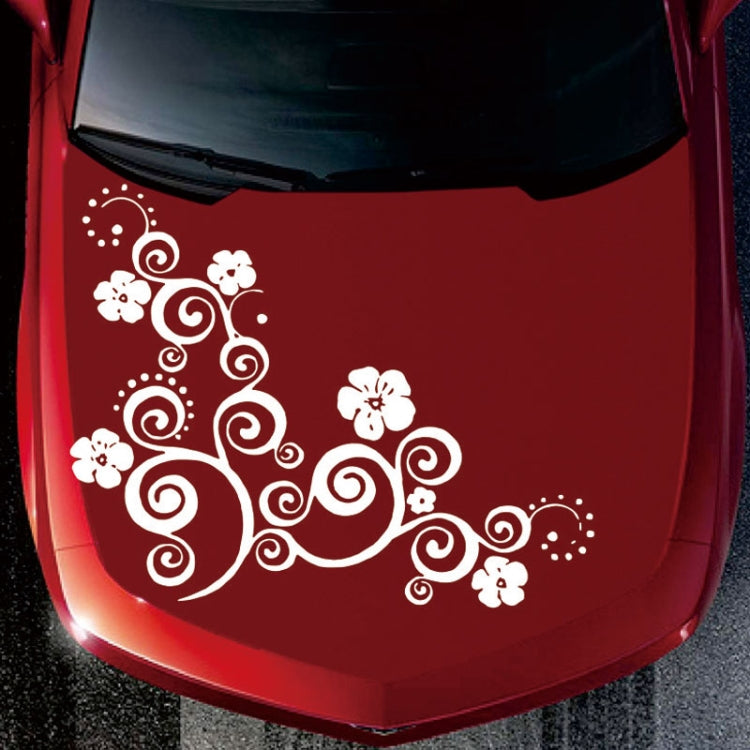 White floral totem car hood sticker on red car hood with swirl and flower icons.