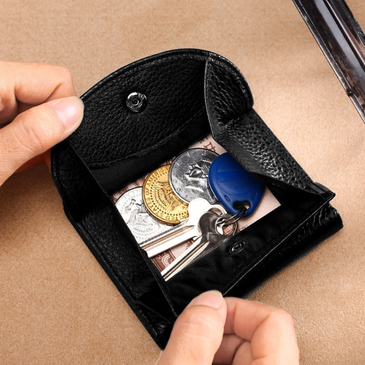 Black leather coin purse with snap closure holding mixed coins and keys