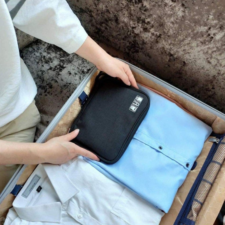Black cable storage pouch inside a bag or suitcase with zipper top