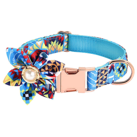 Blue patterned dog collar with adjustable metal buckle, flower bow, and round charm