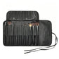 Makeup brush set in a black roll-up case, showing multiple brushes with soft bristles