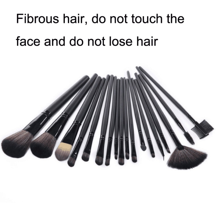 Makeup brush set with dark bristles and black handles, fanned out