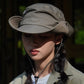 Breathable drawstring fisherman hat in gray worn with chin cord by a person