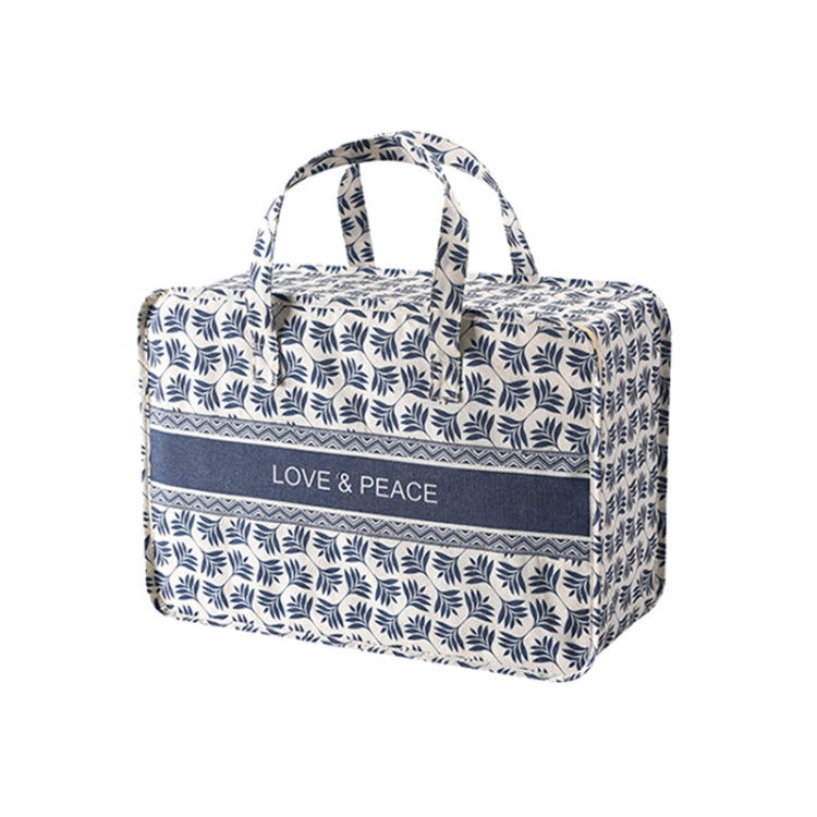 Blue patterned fabric clothes organizer bag with top handles and front “LOVE & PEACE” label