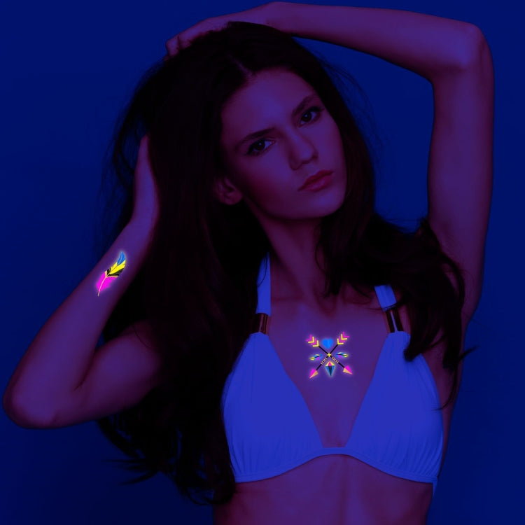 Fluorescent tattoo stickers on skin: neon sun-and-star necklace and matching arm pattern