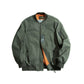 Green bomber jacket on white background, zip front with chest pocket and ribbed cuffs
