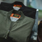 Olive bomber jacket front with zip-up placket and ribbed cuffs