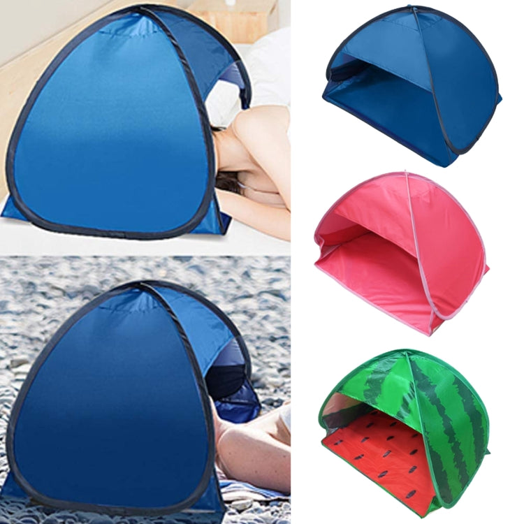 Blue pop-up sunshade tent set up beside a person holding the side opening