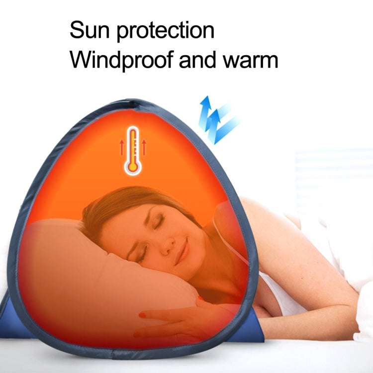 Blue pop-up sunshade tent on a bed with a person lying inside