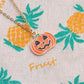 Orange jack-o’-lantern pumpkin pendant charm with black face on gold-tone chain