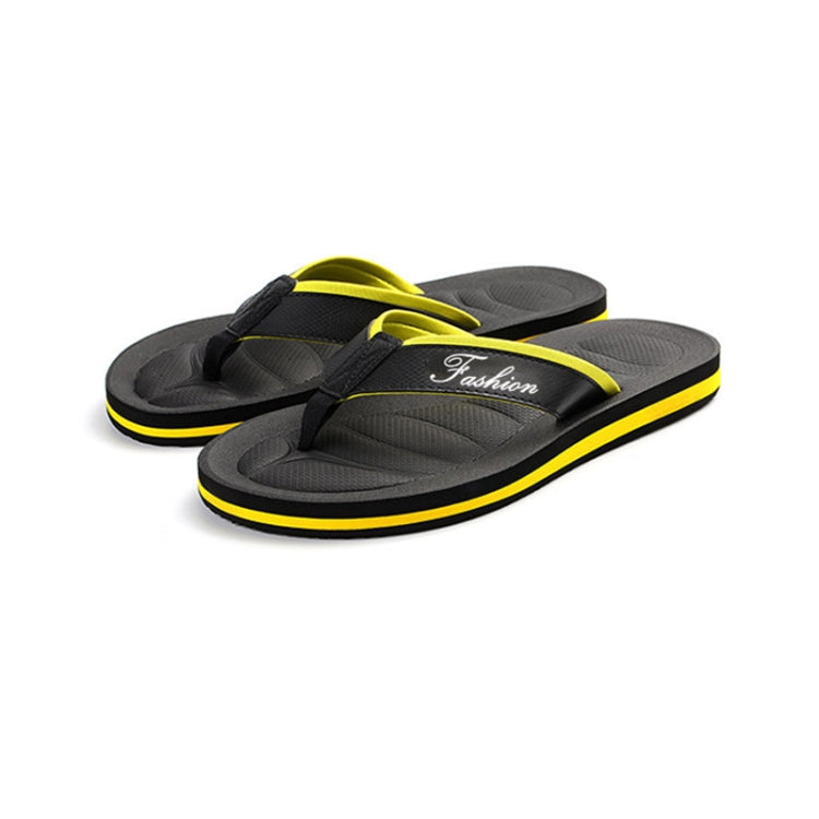 Pair of men's black flip flops with yellow trim, contoured footbed, textured tread sole
