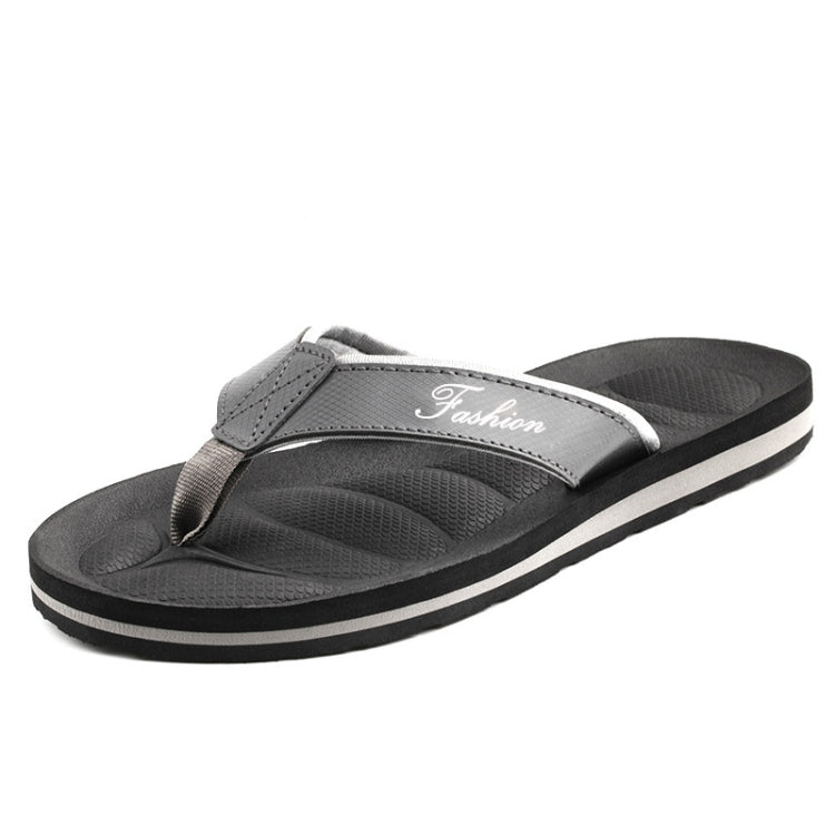 Men's grey flip flops with white trim, strap with "Fashion" text, tread sole