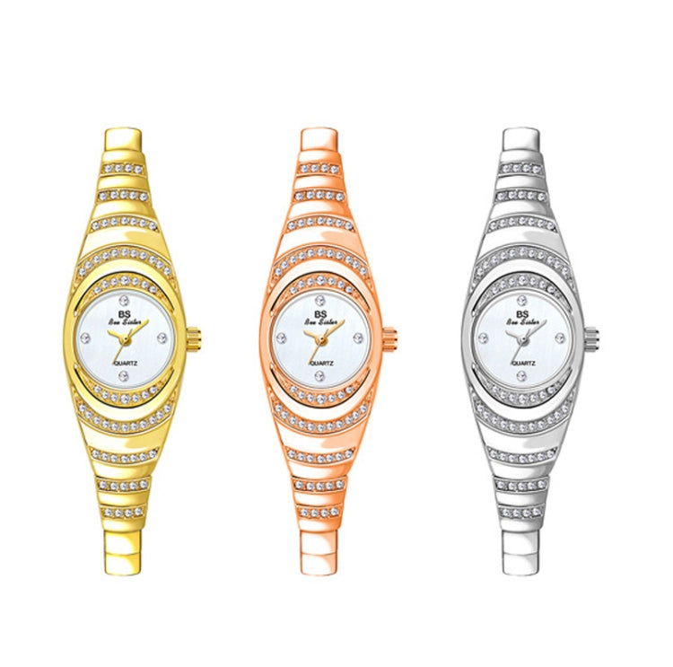 Three oval ladies chain watches with rhinestone details in gold, rose gold, and silver
