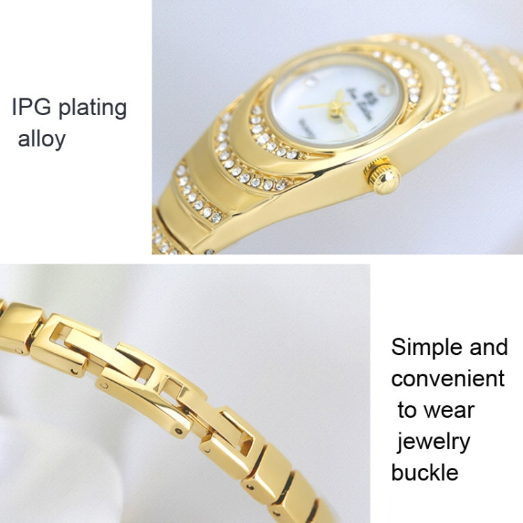 Gold oval ladies watch close-up with rhinestone bezel and link buckle clasp