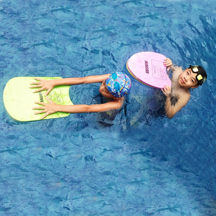 Child holding a pink EVA swim kickboard while floating in the pool