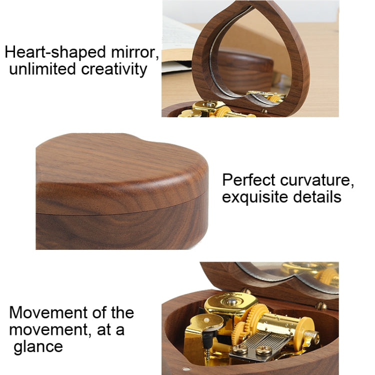 Walnut heart-shaped wooden music box with mirrored lid and gold-tone mechanism, close-up